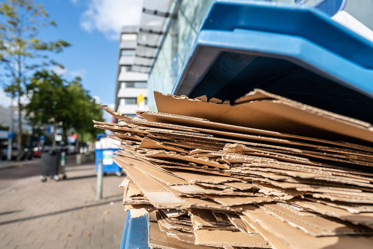 Papelão coletado para reciclagem, representando a matéria-prima para empresas gerarem renda com a venda do resíduo.
