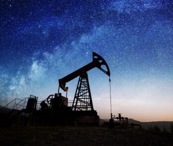 Plataforma de extração de petróleo ao entardecer, com céu estrelado ao fundo. A imagem simboliza o impacto ambiental da indústria petrolífera e está relacionada à obrigatoriedade do inventário de resíduos segundo a Resolução CONAMA nº 313.